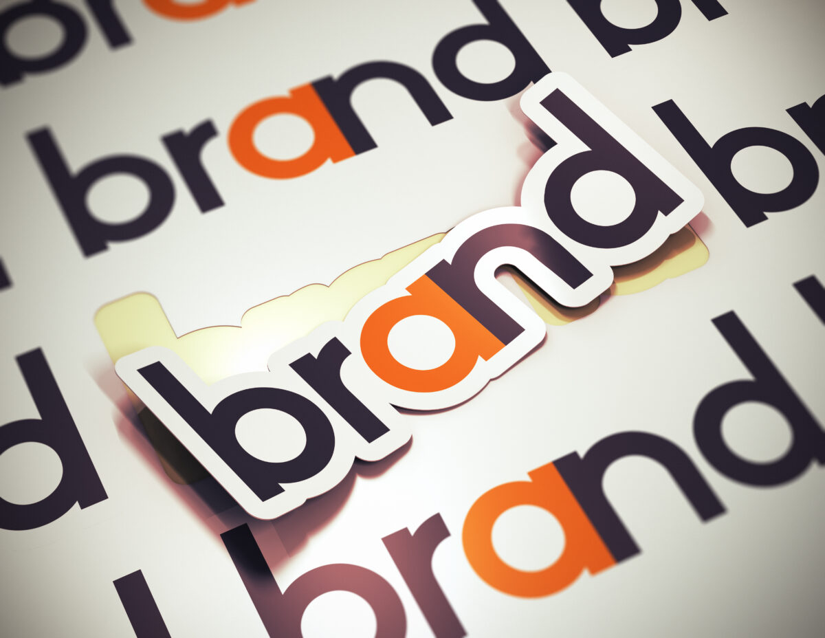 3D rendering of a "Brand" sticker on a beige background, emphasizing the significance of brand identity.