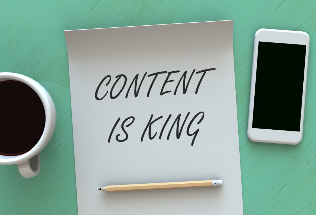 Paper, smartphone, and coffee table - Content is King