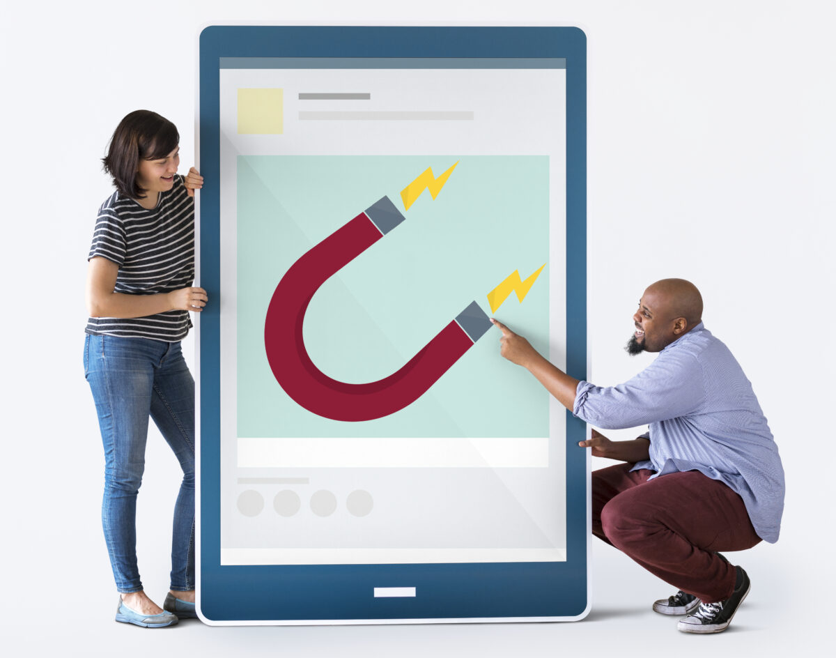 Diverse couple holding tablet with graphics.