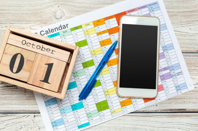 A well-organized social media calendar on a digital tablet surrounded by analytics graphs and content planning notes.